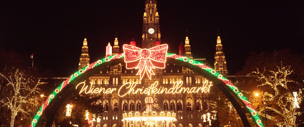 Vienna Christmas Market at Rathausplatz Vienna City Hall and the illuminated entrance to the Christmas market at night