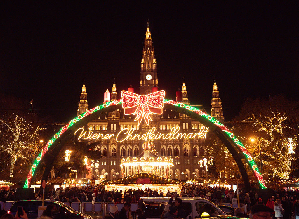 Vienna Christmas Market at Rathausplatz Vienna City Hall and the illuminated entrance to the Christmas market at night